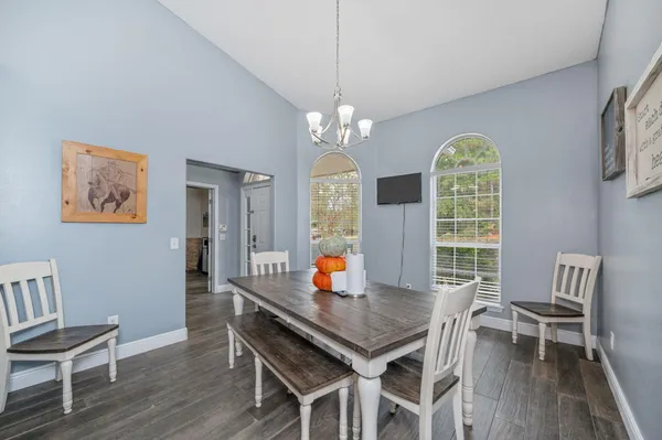 a view of a dining room with furniture window and wooden floor