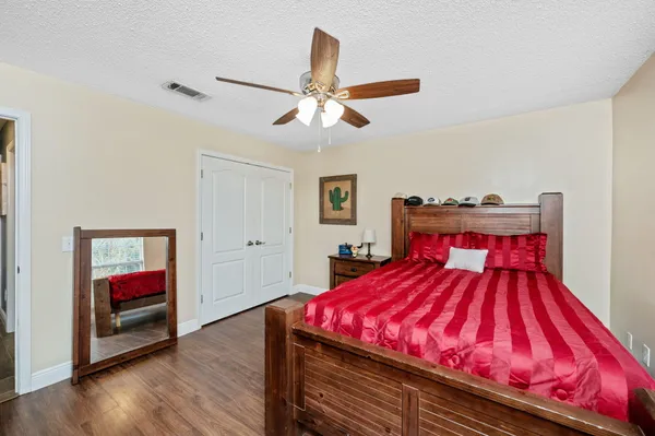 a bedroom with a bed and a chandelier