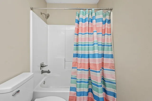 a bathroom with a bathtub and a shower curtain