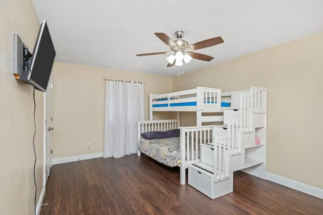 a bedroom with furniture and a window