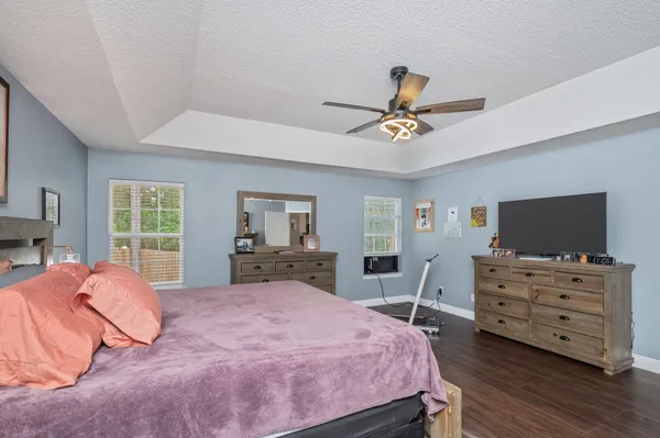 a bedroom with a bed and wooden floor