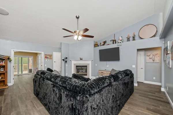 a living room with furniture a fireplace and a flat screen tv