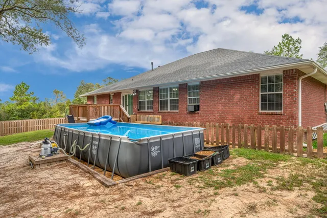 a view of a house with wooden fence
