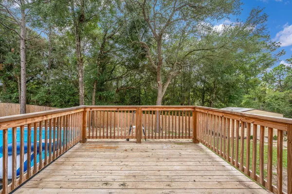 a view of balcony with wooden floor and fence
