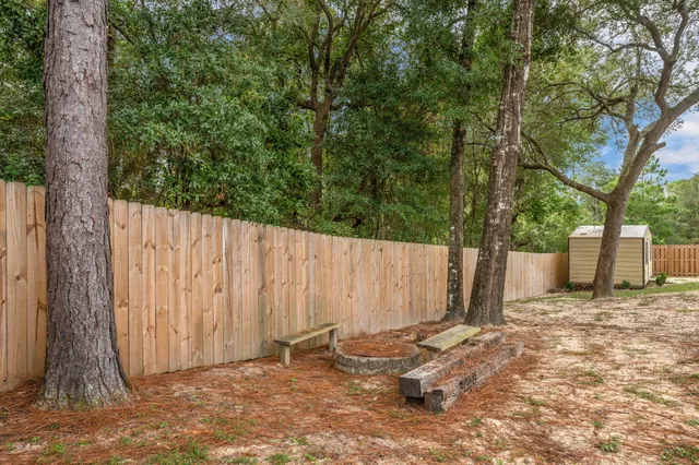 a backyard of a house with lawn chairs