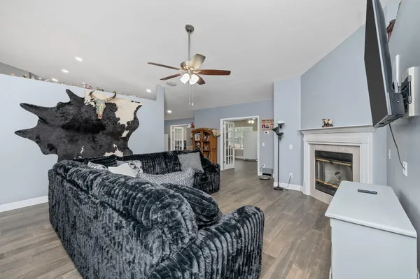 a living room with furniture a fireplace and a flat screen tv