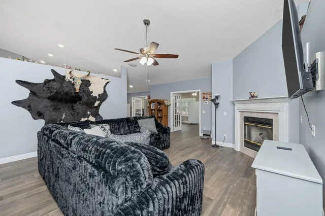 a living room with furniture a fireplace and a flat screen tv