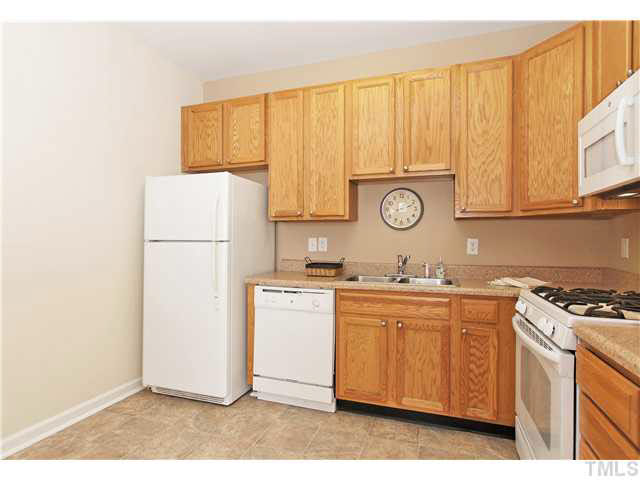 2225 Raven Road, Unit 106 Raleigh, NC 27614 - Photo 7 of 25 a kitchen with a refrigerator and a stove