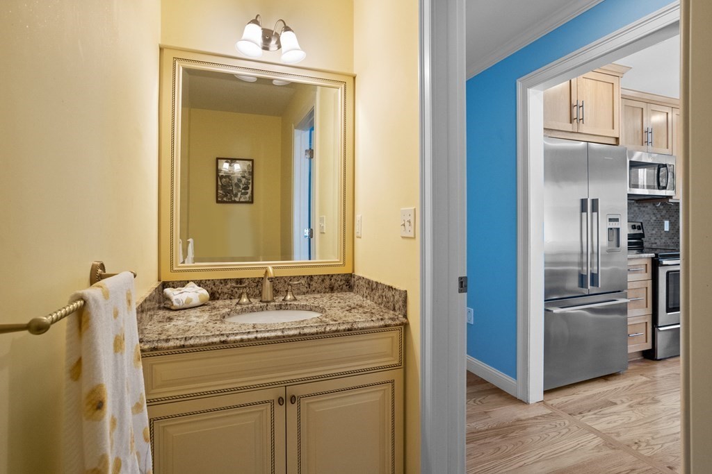 8 High Street, Unit D2 Acton, MA 01720 - Photo 12 of 35 a bathroom with a granite countertop sink and a mirror