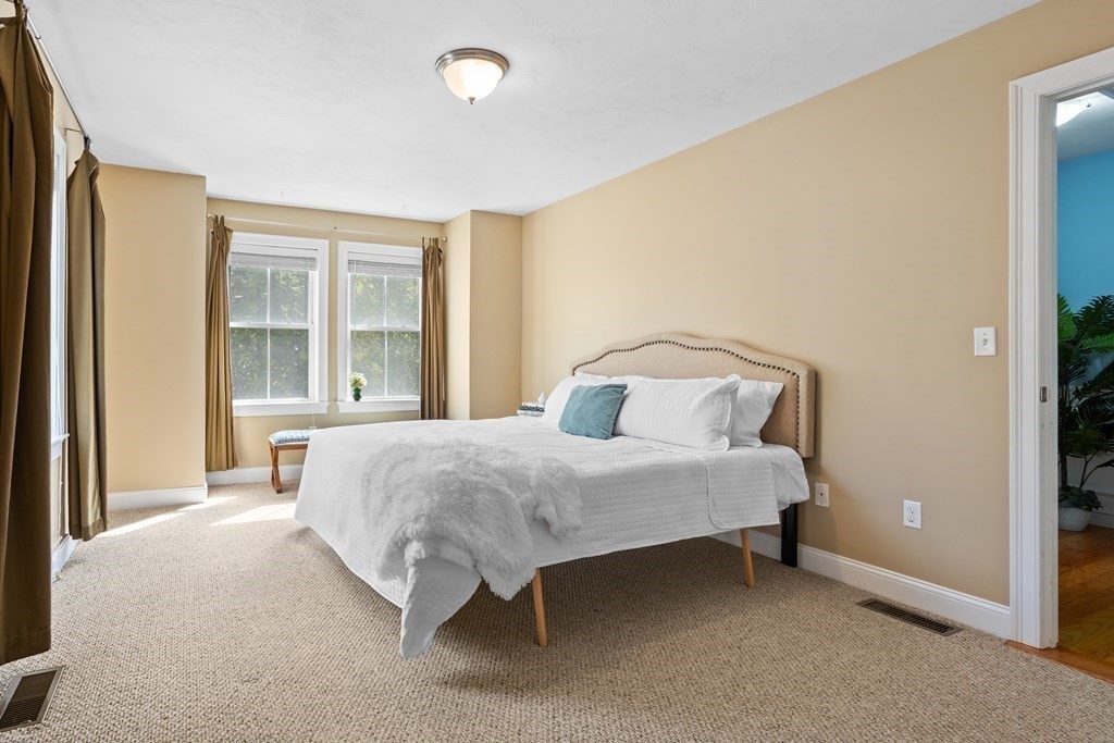 8 High Street, Unit D2 Acton, MA 01720 - Photo 14 of 35 a large bed sitting in a room next to a window