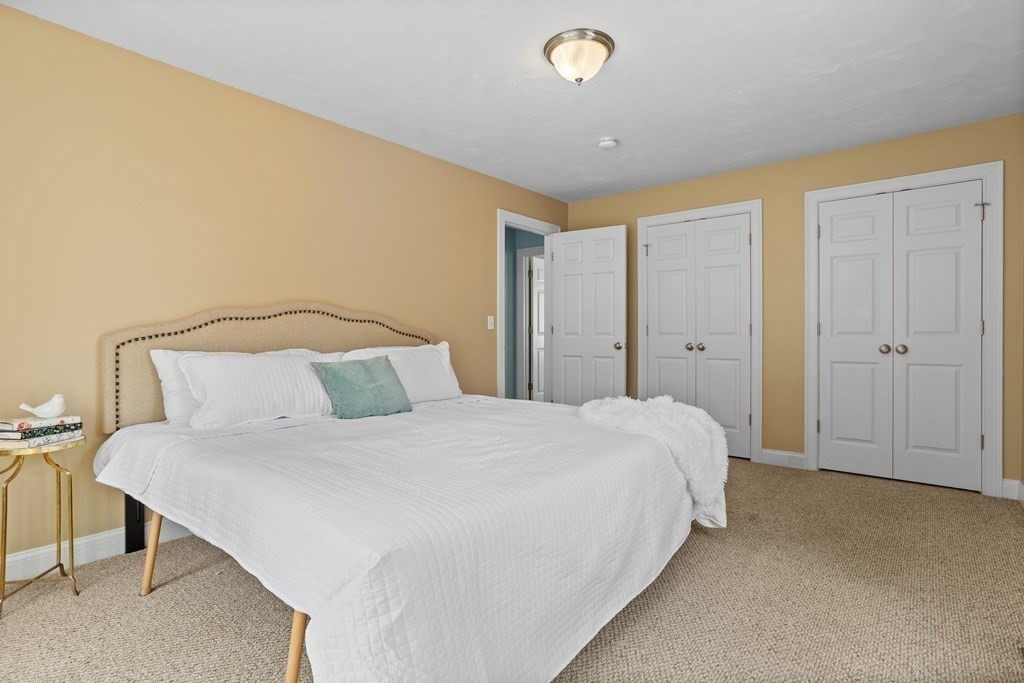 8 High Street, Unit D2 Acton, MA 01720 - Photo 15 of 35 a spacious bedroom with a bed and chair