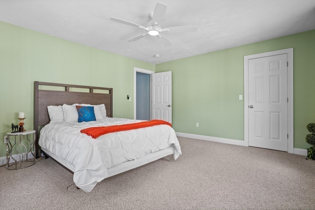 8 High Street, Unit D2 Acton, MA 01720 - Photo 19 of 35 a bedroom with a bed and a ceiling fan