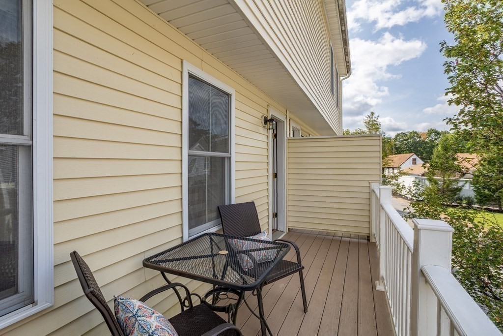 8 High Street, Unit D2 Acton, MA 01720 - Photo 28 of 35 a view of a patio with table and chairs and iron fence