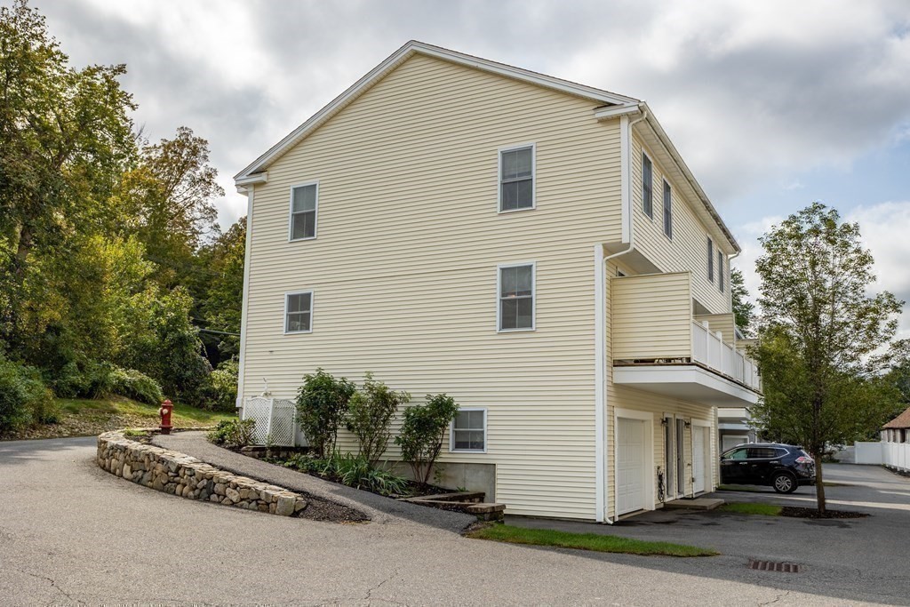 8 High Street, Unit D2 Acton, MA 01720 - Photo 30 of 35 a view of a house with a yard and garage