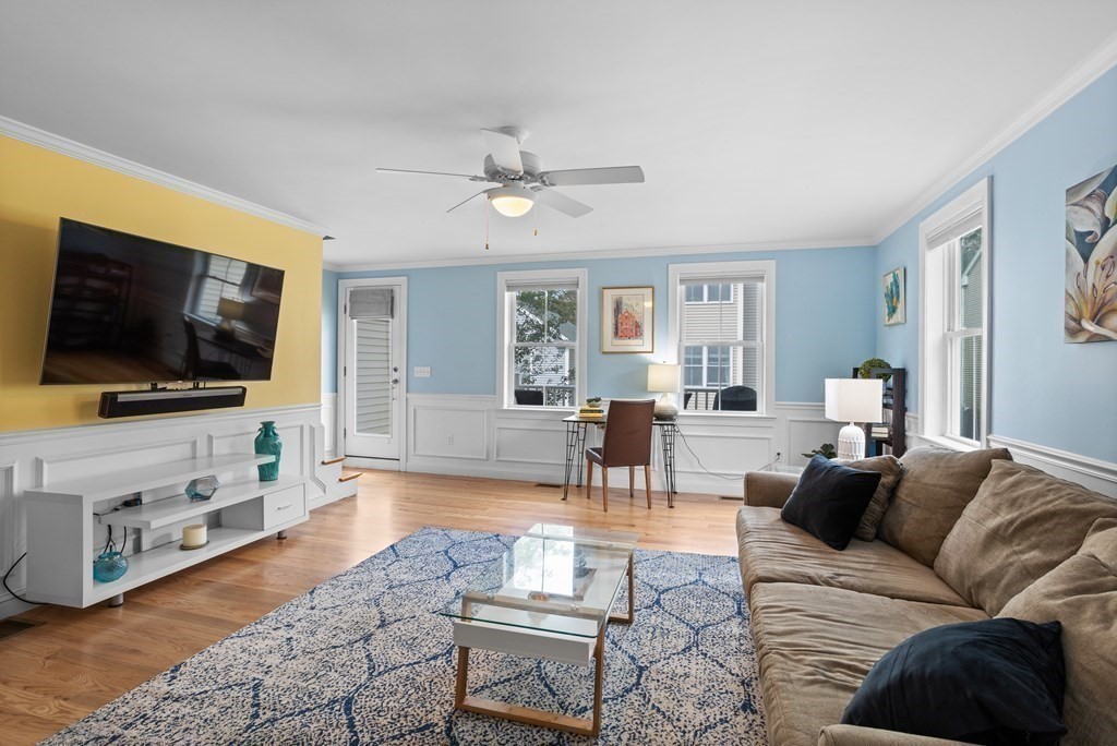 8 High Street, Unit D2 Acton, MA 01720 - Photo 6 of 35 a living room with furniture and a flat screen tv