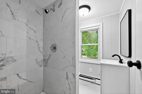 a bathroom with a window and a shower