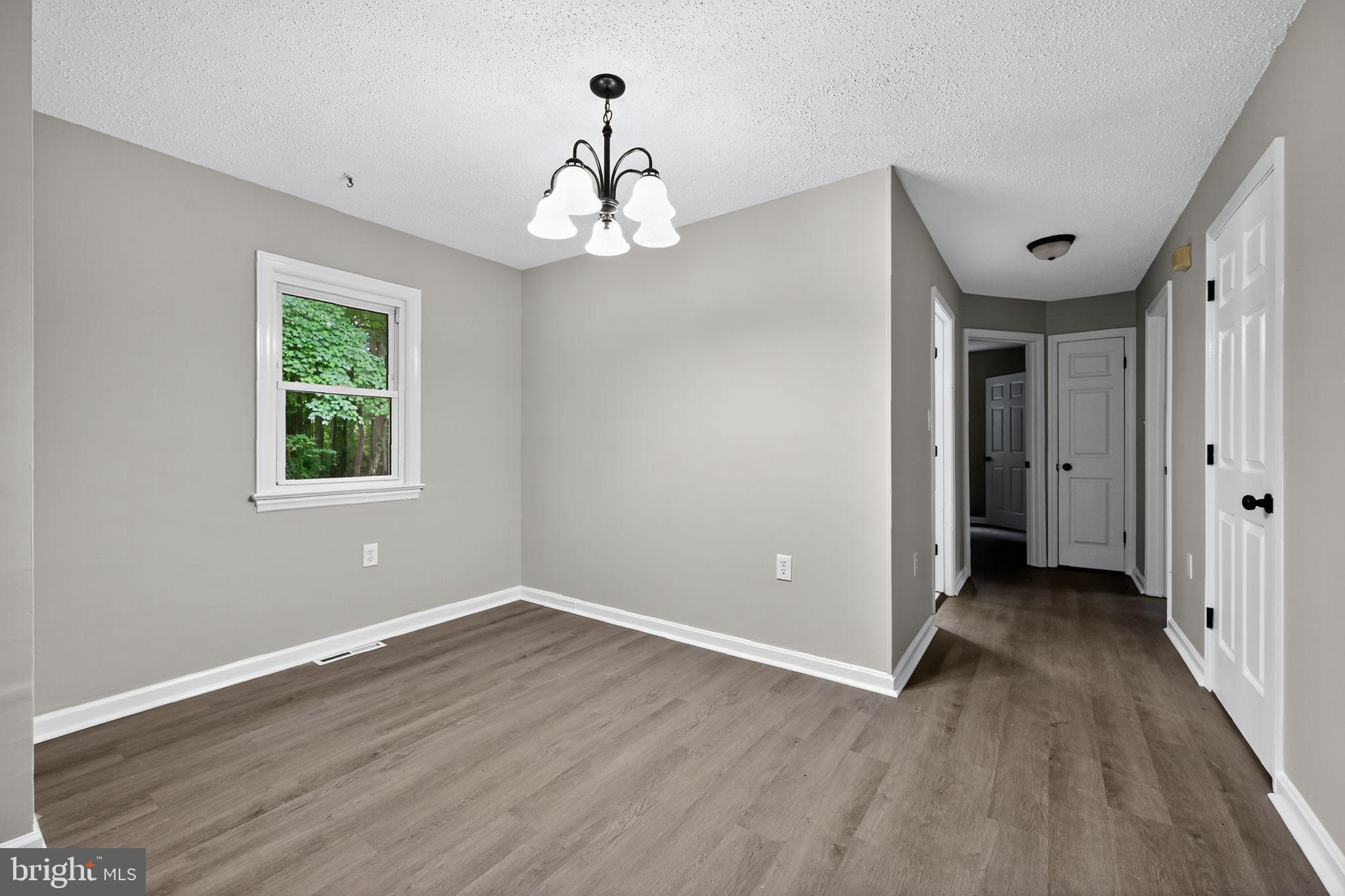 78 Cove Road Dover, DE 19904 - Photo 4 of 15 a view of a big room with wooden floor chandeliers and staircase