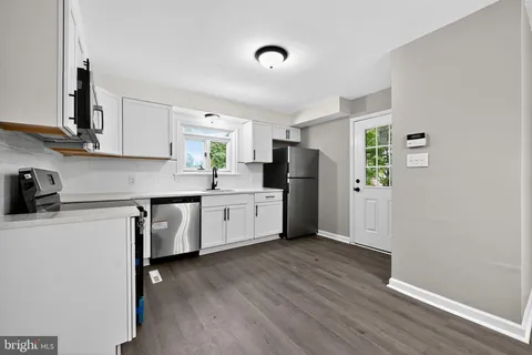 a kitchen with stainless steel appliances a refrigerator sink and microwave
