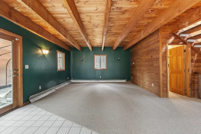 a view of a room with a wooden roof and windows