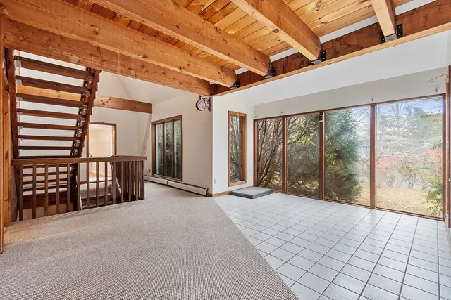 a bedroom with a bed window and flat screen tv