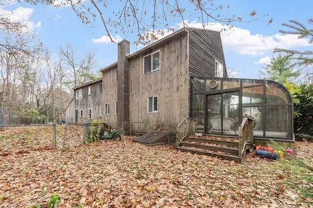 a backyard of a house with barbeque oven table and chairs