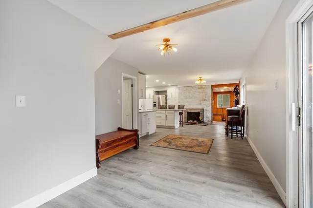 a living room with furniture and kitchen view