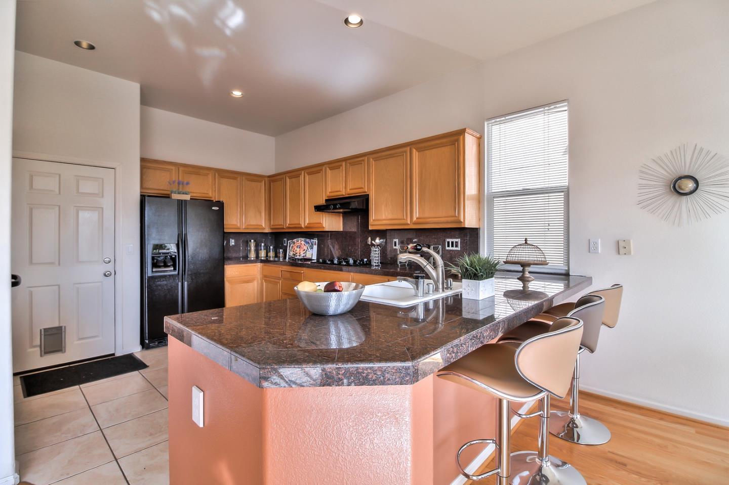 897 Skyridge Drive Pacifica, CA 94044 - Photo 12 of 37 a kitchen with a stove a refrigerator and a dining table