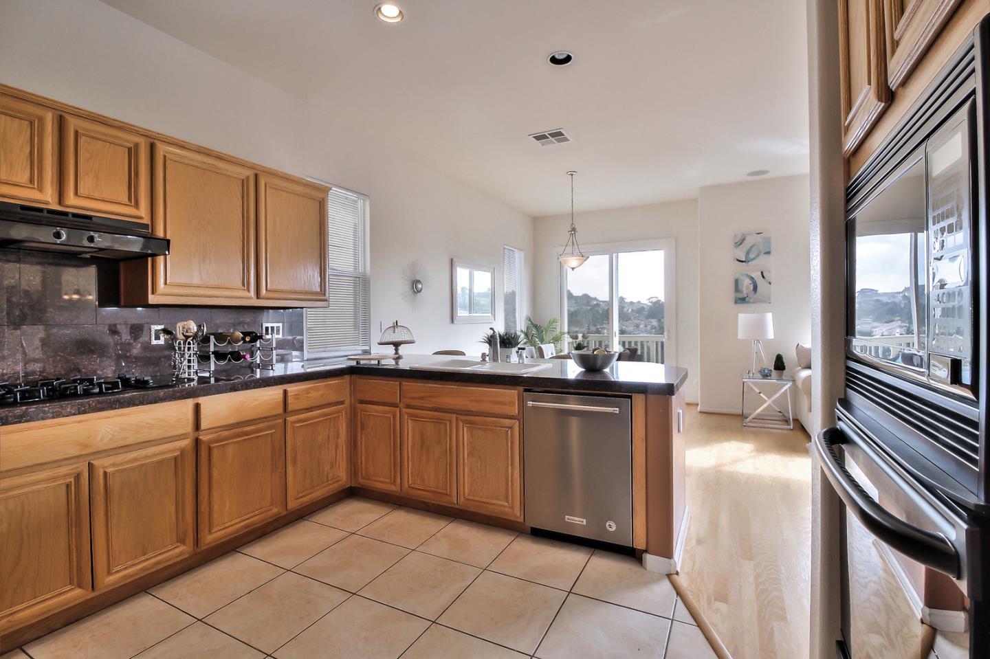 897 Skyridge Drive Pacifica, CA 94044 - Photo 13 of 37 a large kitchen with stainless steel appliances granite countertop a sink and cabinets