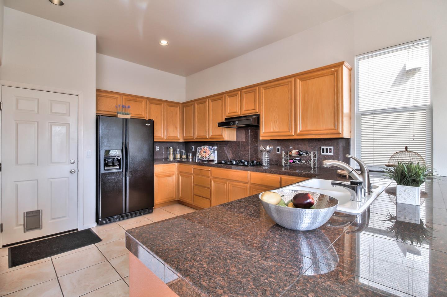 897 Skyridge Drive Pacifica, CA 94044 - Photo 14 of 37 a kitchen with stainless steel appliances granite countertop a sink and a refrigerator