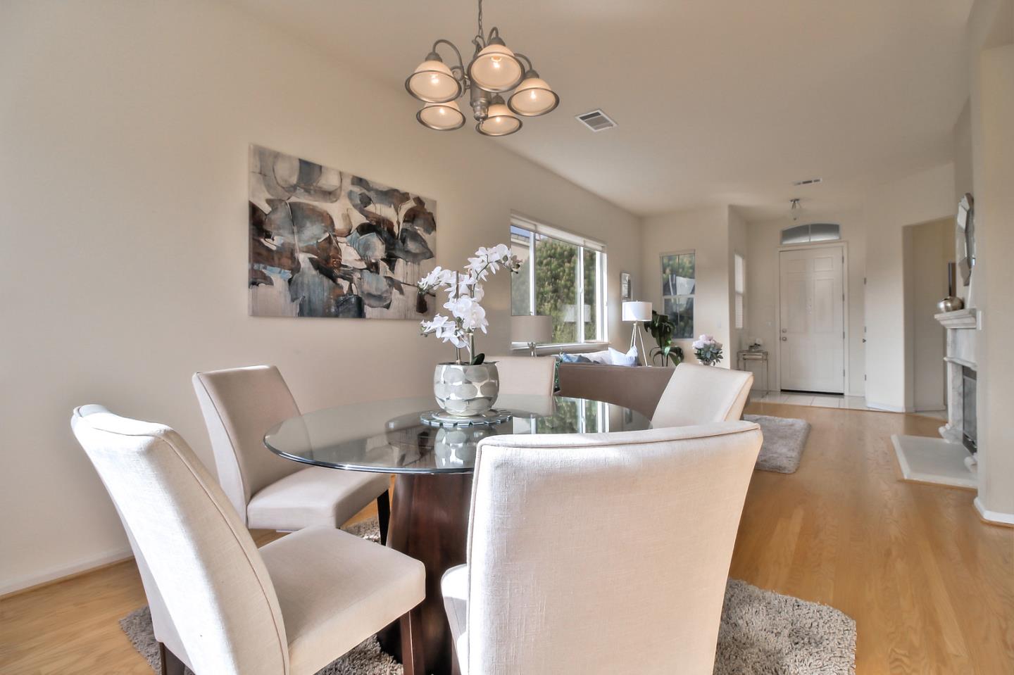 897 Skyridge Drive Pacifica, CA 94044 - Photo 8 of 37 a living room with furniture a large window and a chandelier