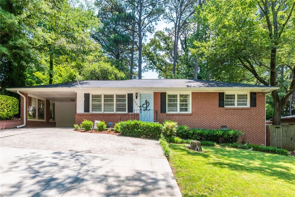 2663 Woodacres Road Northeast Atlanta, GA 30345 - Photo 1 of 1 a front view of a house with a garden
