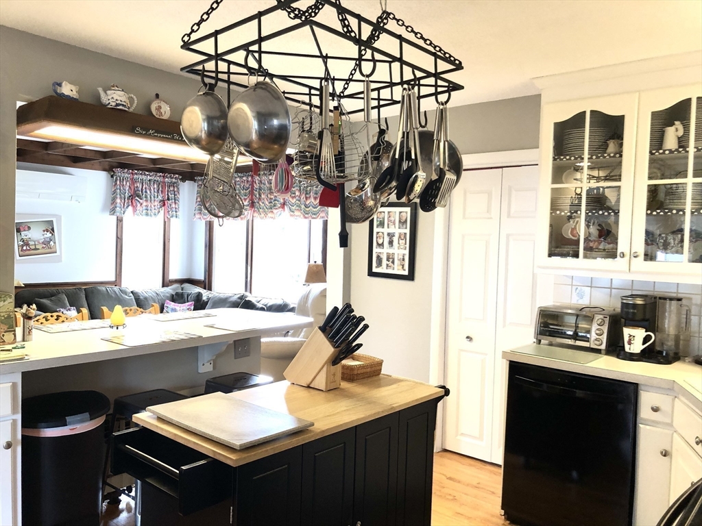 7 Ashbrook Street Springfield, MA 01118 - Photo 3 of 28 a kitchen with a sink a stove and chairs