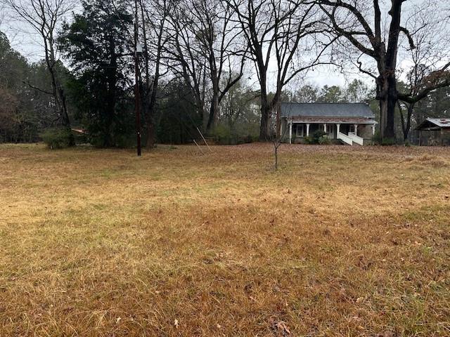 a front view of house with yard and trees