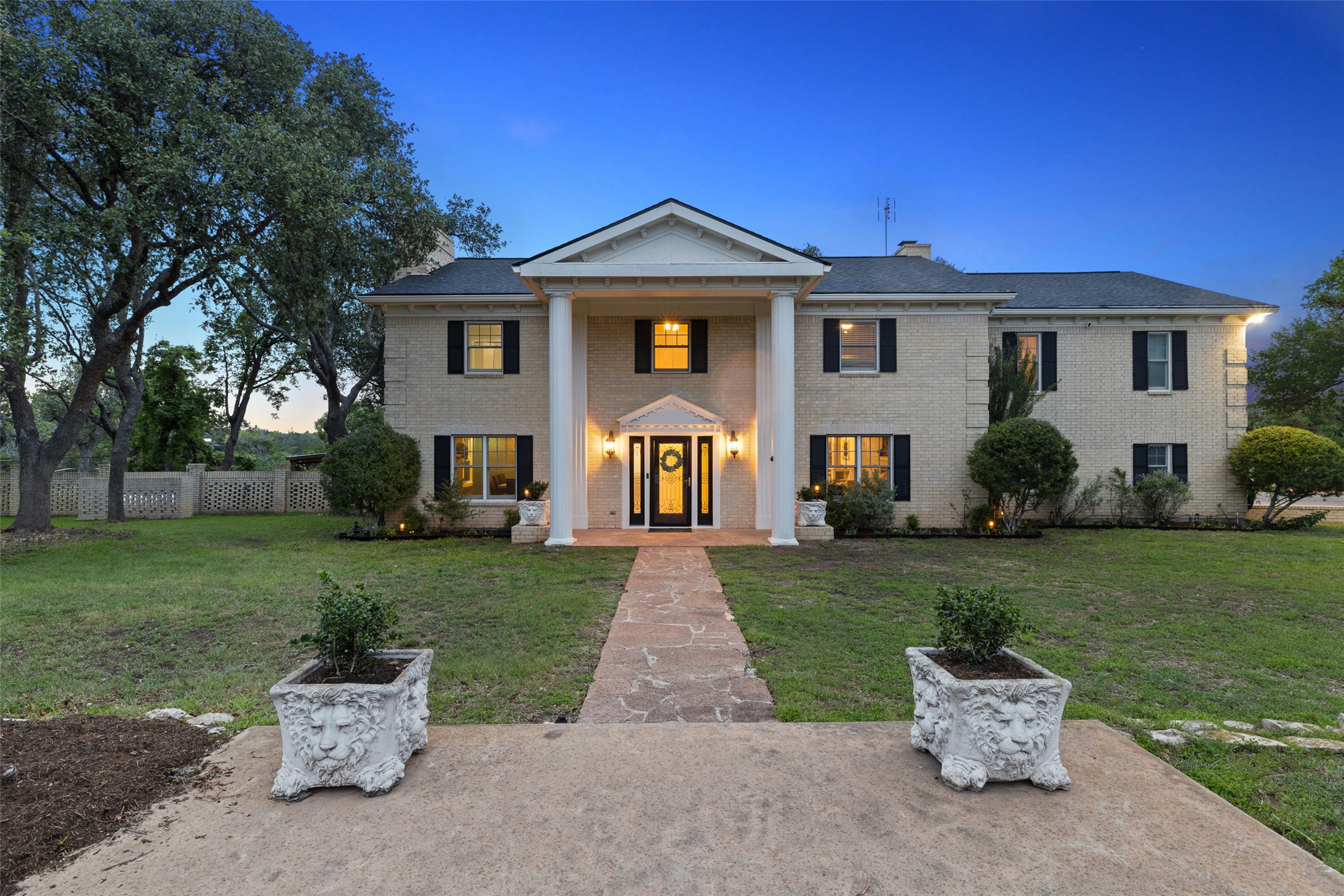 17700 North Rim Drive Leander, TX 78641 - Photo 6 of 38 Greek revival inspired property with a chimney and brick siding