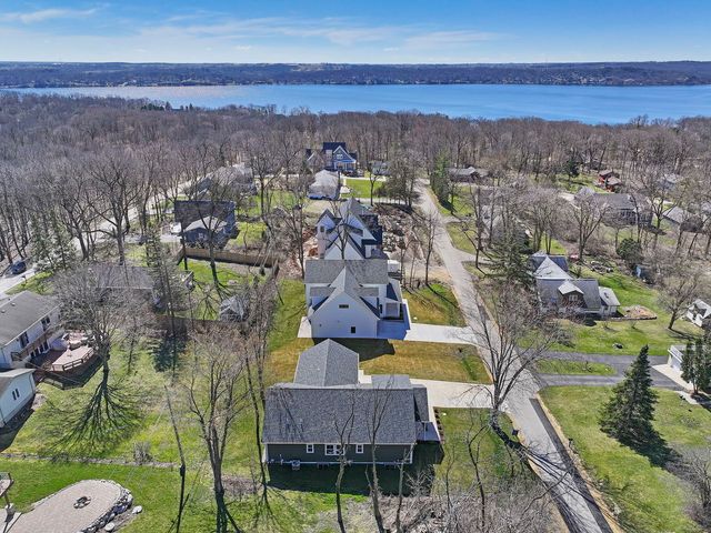 a view of a house with yard and trees
