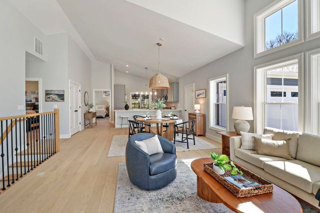 a living room with furniture fireplace and a window