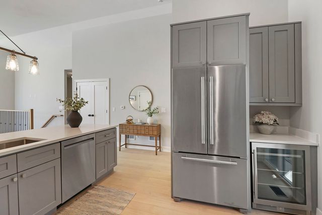 a kitchen with stainless steel appliances a refrigerator and a sink