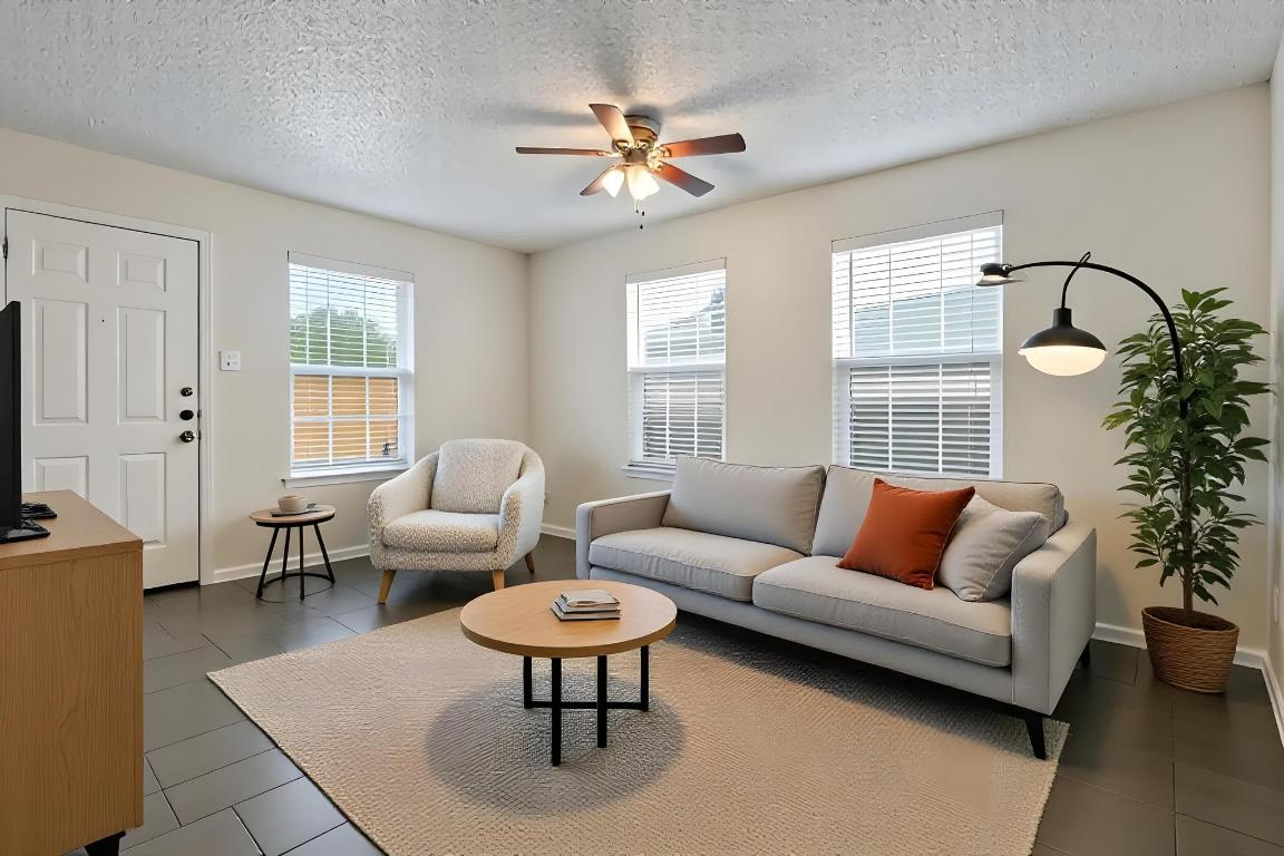 1115 Brookswood Avenue, Unit B Austin, TX 78721 - Photo 11 of 34 a living room with furniture a table and a large window