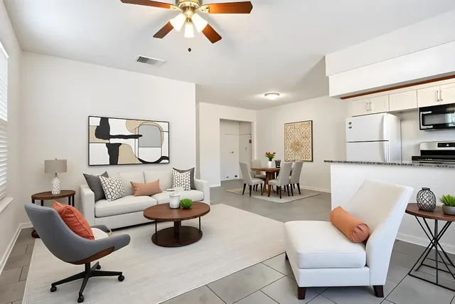 a living room with furniture and kitchen view