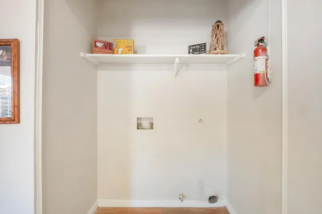 a view of a room with wooden floor and a window