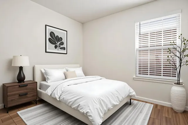 a bedroom with a bed and a window