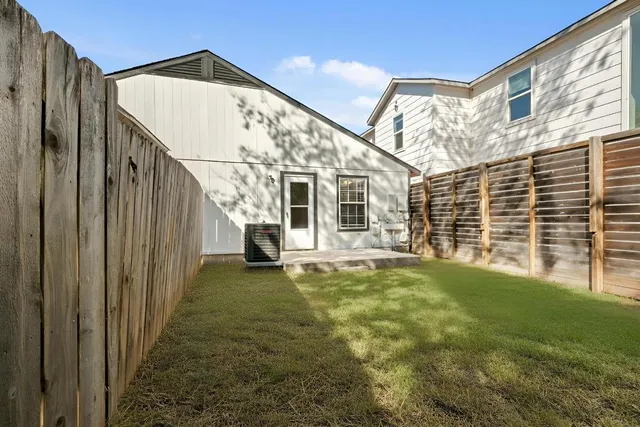 an aerial view of a house with garden space and street view