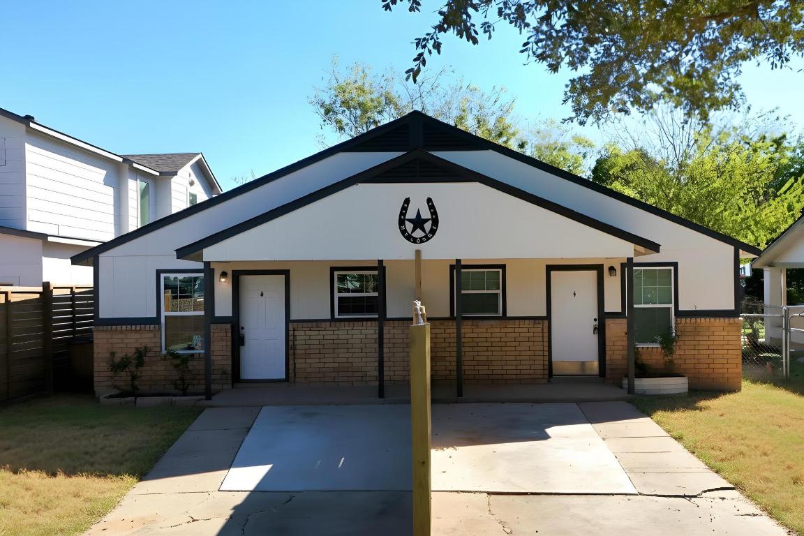 1115 Brookswood Avenue, Unit B Austin, TX 78721 - Photo 3 of 34 a front view of a house with a yard