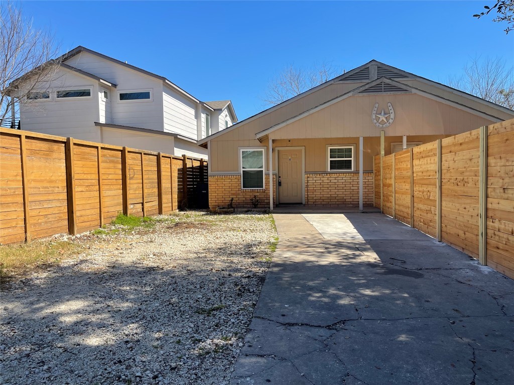 1115 Brookswood Avenue, Unit B Austin, TX 78721 - Photo 6 of 34 a front view of a house with a yard