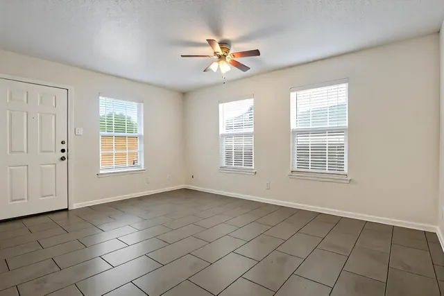 a living room with furniture a table and a large window