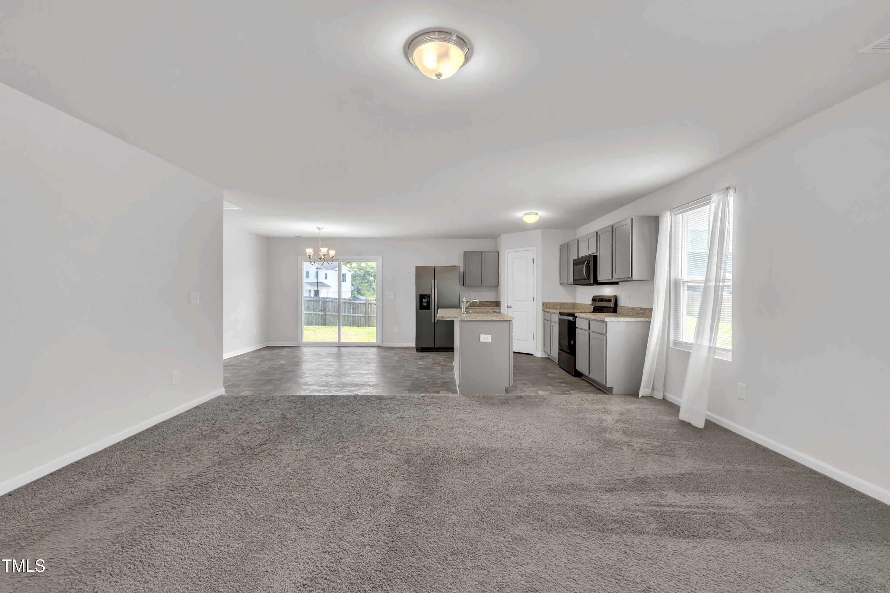 146 Maple Tree Lane Clayton, NC 27527 - Photo 12 of 50 a view of a kitchen with a sink and refrigerator