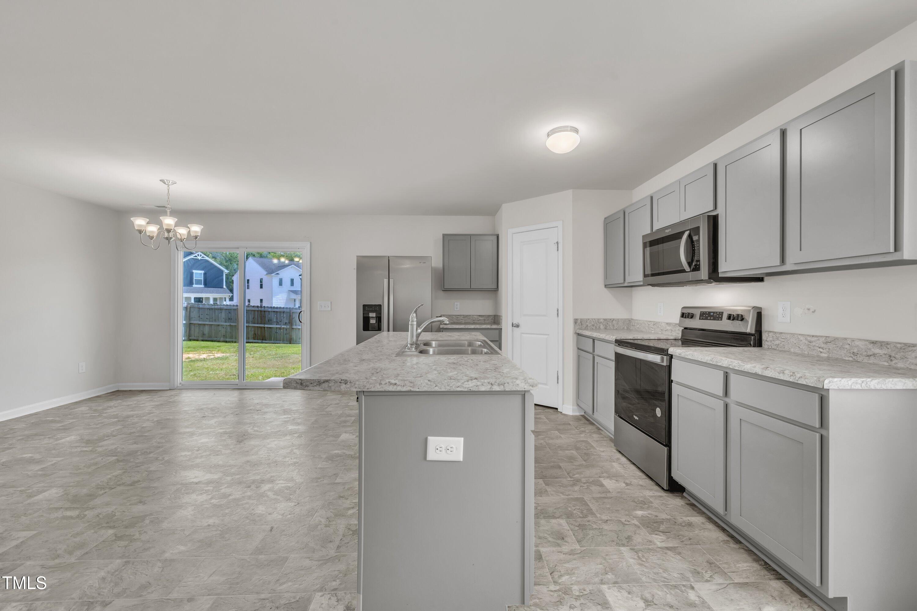146 Maple Tree Lane Clayton, NC 27527 - Photo 13 of 50 a kitchen with stainless steel appliances granite countertop a stove a sink and a microwave