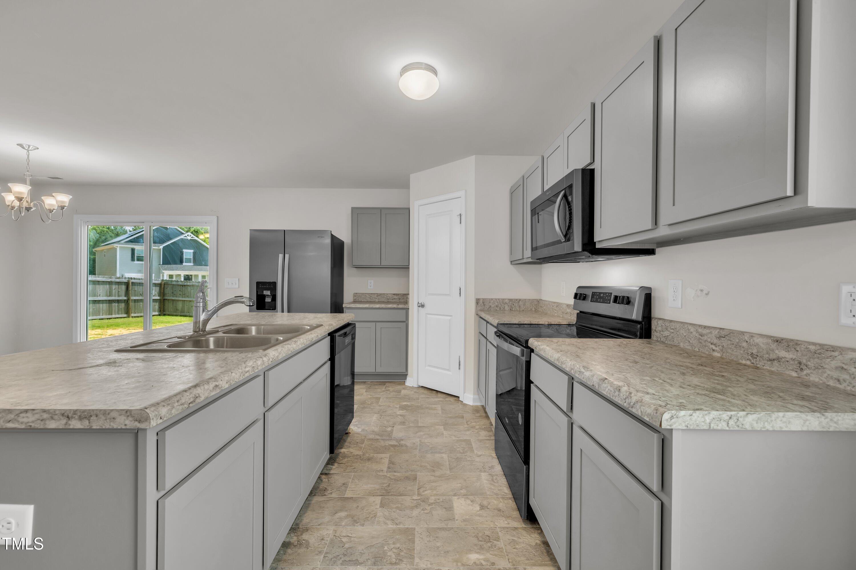 146 Maple Tree Lane Clayton, NC 27527 - Photo 15 of 50 a kitchen with stainless steel appliances granite countertop a sink stove and cabinets