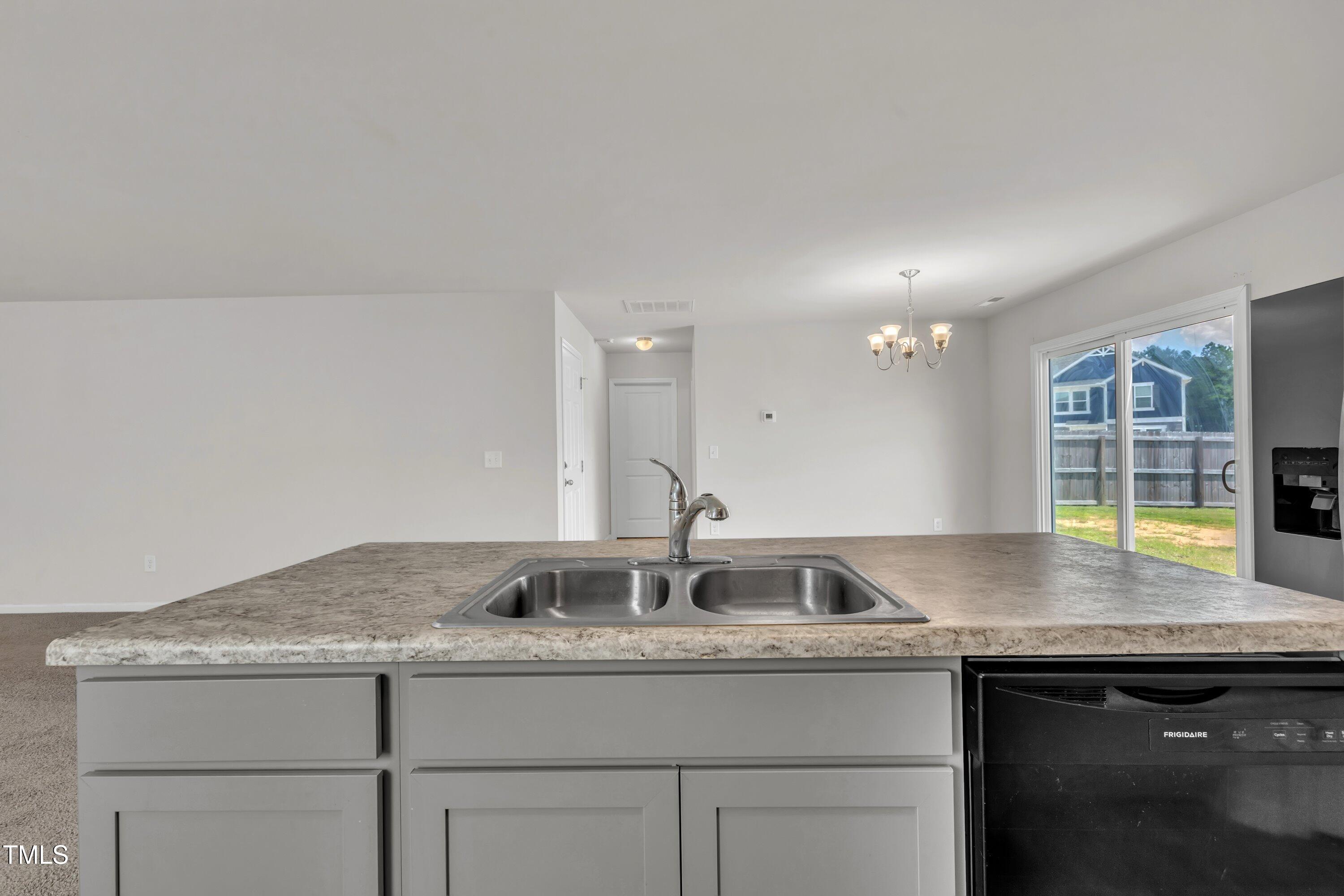 146 Maple Tree Lane Clayton, NC 27527 - Photo 17 of 50 a kitchen with granite countertop a sink and a stove