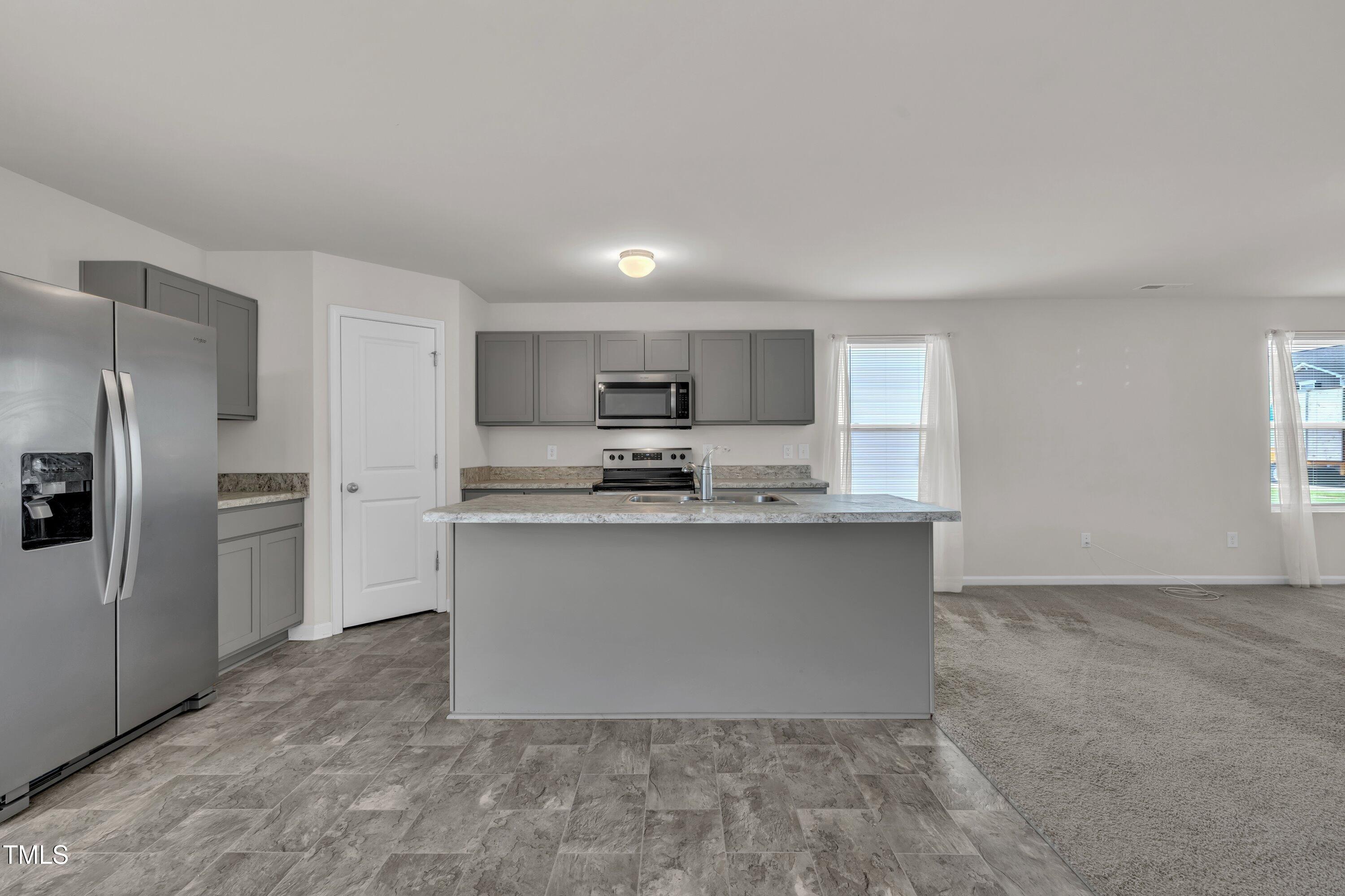 146 Maple Tree Lane Clayton, NC 27527 - Photo 19 of 50 a kitchen with stainless steel appliances granite countertop a refrigerator a stove a sink and a oven